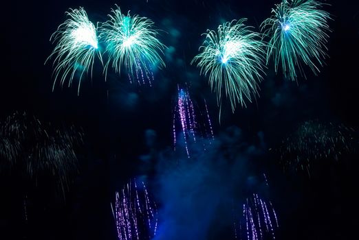 Colorful blue fireworks on the black sky background