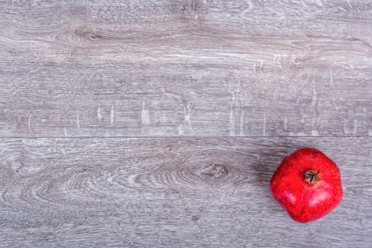 Red pomegranate on a wooden background