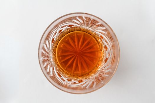 A glass containing a double scotch with no ice, from above