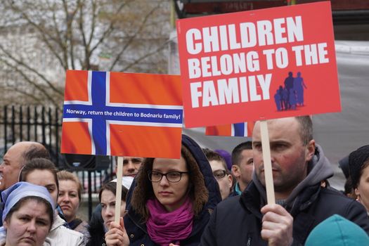 UNITED KINGDOM, London: Protesters hold placards reading Children belong to the family or Norway, return the children to Bodnariu family during a demonstration to condemn legal kidnapping in Norway, in London, UK, on April 16, 2016. 