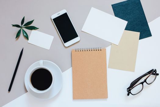Creative flat lay photo of workspace desk with smartphone, coffee, tag, letter and notebook with copy space background, minimal style
