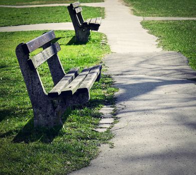 background two old abandoned benches in park
