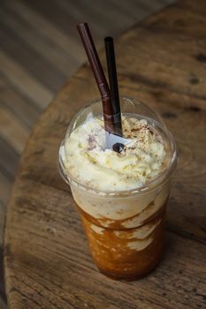 Iced coffee smoothie on wood background, soft focus , selective of focus