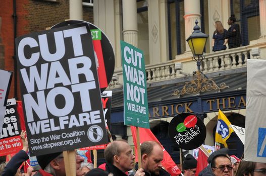 UNITED KINGDOM, London: A protester holds a sign reading 'Cut war not welfare' as ten of thousands march and protest against the Tories government and demanded David Cameron's resignation in Trafalgar square in London on April 16, 2016. Protesters descended to London in hundreds of coaches from all over the UK to take part in this anti-austerity protest.