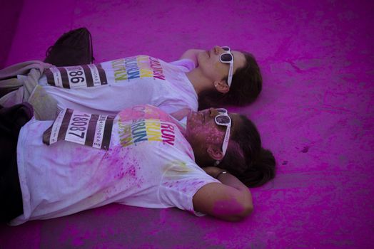 FRANCE, Paris : People participate in the Color Run 2016 in front of the Eiffel Tower in Paris on April 17, 2016. The Color Run is a five kilometres paint race without winners nor prizes, while runners are showered with colored powder at stations along the run. 