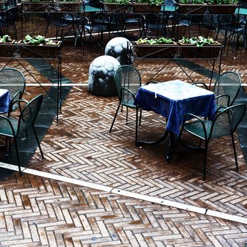 Chairs and Tables in a Street Cafe under the Rain, Vintage Style Toned Picture