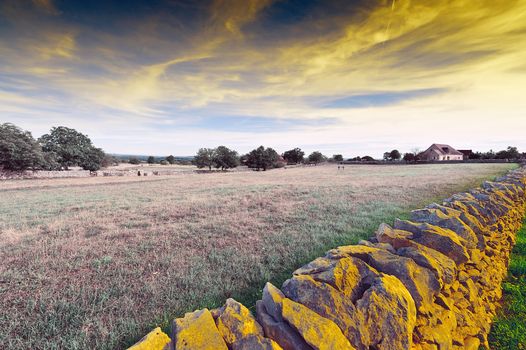 Pasture Divided into Section by the Stone Wall at Sunset, Vintage Style Toned Picture
