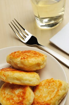 close up  of gold cheese cottage with fork and juice