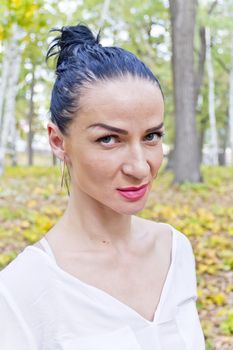 Portrait of Caucasian brunette in autumn park