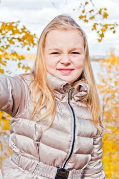 Photo of cute smiling girl in autumn