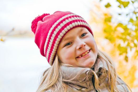 Portrait of cute smiling girl with blond hair