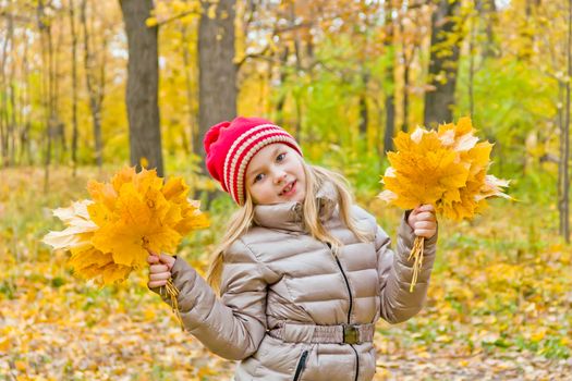 Photo of cute dancing girl in autumn
