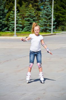 Photo of cute girl on roller skates in summer