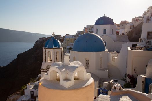 Blue domes and their bell tower in Oia. Santorini