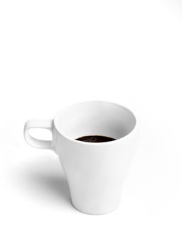 White porcelain half full cup of tasty morning coffee isolated on white background.