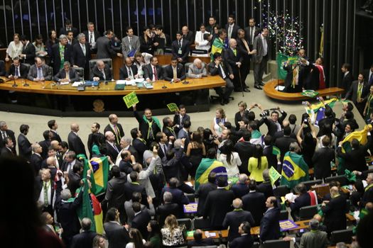 BRAZIL, Brasilia: A members of parliament tossed confetti at the impeachment proceedings for President Dilma Rousseff on April 17, 2016 in Brasilia. Some members of parliament began signing, shouting and throwing confetti as the proceedings turned chaotic. The impeachment issue has divided Brazil over the past few weeks with some in support of impeaching Rousseff, while others are strongly opposed. Brazil's lower house is voting on whether to continue impeachment proceedings. 342 out of 513 votes are needed to continue the proceedings to the upper house.