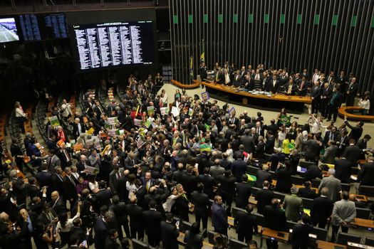 BRAZIL, Brasilia: Members of parliament began impeachment proceedings for President Dilma Rousseff on April 17, 2016 in Brasilia. Some members of parliament began signing, shouting and throwing confetti as the proceedings turned chaotic. The impeachment issue has divided Brazil over the past few weeks with some in support of impeaching Rousseff, while others are strongly opposed. Brazil's lower house is voting on whether to continue impeachment proceedings. 342 out of 513 votes are needed to continue the proceedings to the upper house.