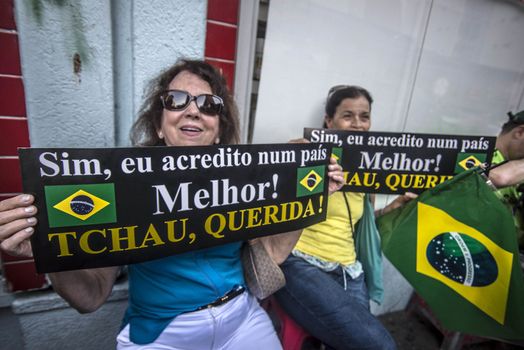 BRAZIl, Sao Paulo: Women hold placards which read Yes, I believe in a better country! Bye, honey! as thousands of activists supporting the impeachment of President Dilma Rousseff take part in a protest in Sao Paulo, on April 17, 2016. Brazilian lawmakers on Sunday reached the two thirds majority necessary to authorize impeachment proceedings against President Dilma Rousseff. The lower house vote sends Rousseff's case to the Senate, which can vote to open a trial. A two thirds majority in the upper house would eject her from office. Rousseff, whose approval rating has plunged to a dismal 10 percent, faces charges of embellishing public accounts to mask the budget deficit during her 2014 reelection.