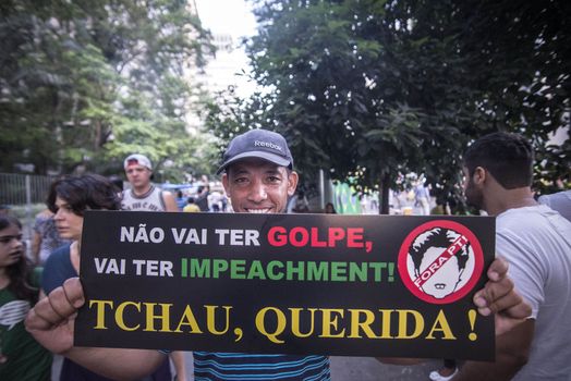 BRAZIl, Sao Paulo: A man holds a placard which reads It won't be a coup, it will be an impeachment! Bye, honey! as thousands of activists supporting the impeachment of President Dilma Rousseff take part in a protest in Sao Paulo, on April 17, 2016. Brazilian lawmakers on Sunday reached the two thirds majority necessary to authorize impeachment proceedings against President Dilma Rousseff. The lower house vote sends Rousseff's case to the Senate, which can vote to open a trial. A two thirds majority in the upper house would eject her from office. Rousseff, whose approval rating has plunged to a dismal 10 percent, faces charges of embellishing public accounts to mask the budget deficit during her 2014 reelection.