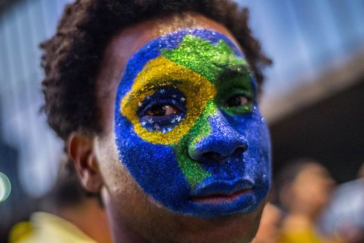 BRAZIl, Sao Paulo: A demonstrator show a Brazilian national flag makeup as thousands of activists supporting the impeachment of President Dilma Rousseff take part in a protest in Sao Paulo, on April 17, 2016. Brazilian lawmakers on Sunday reached the two thirds majority necessary to authorize impeachment proceedings against President Dilma Rousseff. The lower house vote sends Rousseff's case to the Senate, which can vote to open a trial. A two thirds majority in the upper house would eject her from office. Rousseff, whose approval rating has plunged to a dismal 10 percent, faces charges of embellishing public accounts to mask the budget deficit during her 2014 reelection.