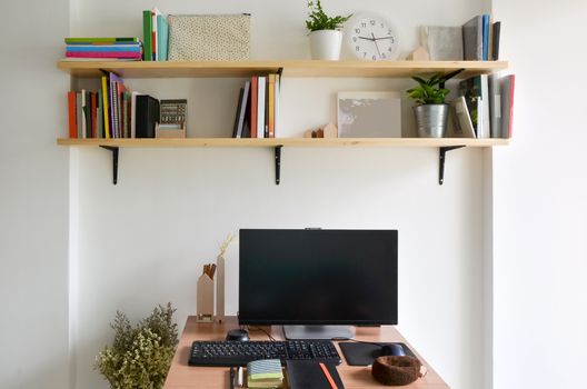 Home office working space with wooden book shelf