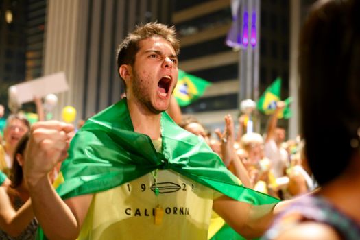 BRAZIl, Sao Paulo: A man shouts on the Avenida Paulista as thousands of activists supporting the impeachment of President Dilma Rousseff take part in a protest in Sao Paulo, on April 17, 2016. Brazilian lawmakers on Sunday reached the two thirds majority necessary to authorize impeachment proceedings against President Dilma Rousseff. The lower house vote sends Rousseff's case to the Senate, which can vote to open a trial. A two thirds majority in the upper house would eject her from office. Rousseff, whose approval rating has plunged to a dismal 10 percent, faces charges of embellishing public accounts to mask the budget deficit during her 2014 reelection.