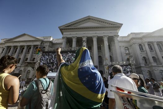 BRAZIL, Curitiba: Activists supporting the impeachment of Brazilian President Dilma Rousseff follow on a big screen as lawmakers vote on whether the impeachment of Rousseff will move forward, in Curitiba, southern Brazil, on April 17, 2016. Brazilian lawmakers on Sunday reached the two thirds majority necessary to authorize impeachment proceedings against President Dilma Rousseff. The lower house vote sends Rousseff's case to the Senate, which can vote to open a trial. A two thirds majority in the upper house would eject her from office. Rousseff, whose approval rating has plunged to a dismal 10 percent, faces charges of embellishing public accounts to mask the budget deficit during her 2014 reelection.