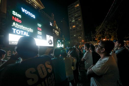 BRAZIL, Curitiba: Activists supporting the impeachment of Brazilian President Dilma Rousseff follow on a big screen as lawmakers vote on whether the impeachment of Rousseff will move forward, in Curitiba, southern Brazil, on April 17, 2016. Brazilian lawmakers on Sunday reached the two thirds majority necessary to authorize impeachment proceedings against President Dilma Rousseff. The lower house vote sends Rousseff's case to the Senate, which can vote to open a trial. A two thirds majority in the upper house would eject her from office. Rousseff, whose approval rating has plunged to a dismal 10 percent, faces charges of embellishing public accounts to mask the budget deficit during her 2014 reelection.