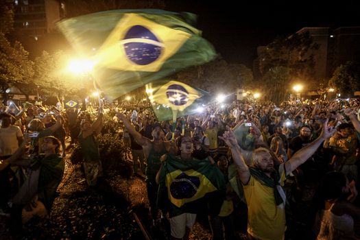 BRAZIL, Curitiba: Activists supporting the impeachment of Brazilian President Dilma Rousseff follow on a big screen as lawmakers vote on whether the impeachment of Rousseff will move forward, in Curitiba, southern Brazil, on April 17, 2016. Brazilian lawmakers on Sunday reached the two thirds majority necessary to authorize impeachment proceedings against President Dilma Rousseff. The lower house vote sends Rousseff's case to the Senate, which can vote to open a trial. A two thirds majority in the upper house would eject her from office. Rousseff, whose approval rating has plunged to a dismal 10 percent, faces charges of embellishing public accounts to mask the budget deficit during her 2014 reelection.