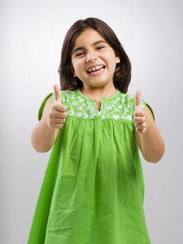 Studio portrait of a beautiful girl with thumbs up, isolated over white background