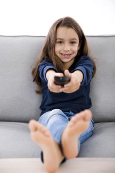 Little girl holding a TV remote control