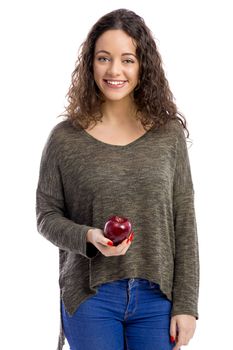 Portrait of a beautiful woman holding a fresh red apple, isolated in white background