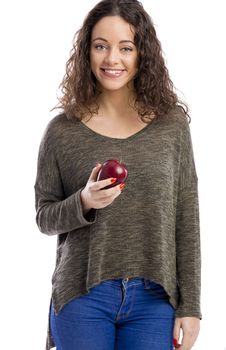 Portrait of a beautiful woman holding a fresh red apple, isolated in white background