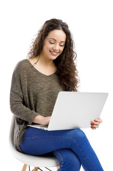 Beautiful and happy woman working with a laptop, isolated over white background 