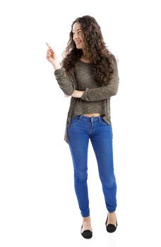 Beautiful and happy woman pointing, isolated over white background 