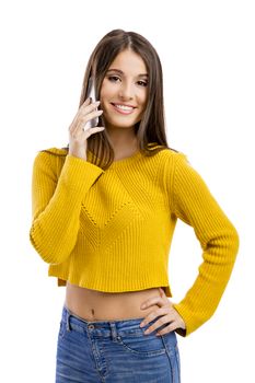 Beautiful girl making a phone call, isolated over white background