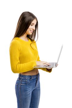 Beautiful and happy girl working with a laptop, isolated over white background 