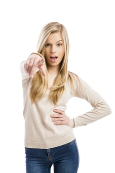 Beautiful and happy teenage girl pointing, isolated over white background 