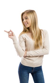 Beautiful and happy teenage girl pointing to teh side, isolated over white background 