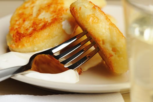 Macro of cheese cottage on fork with cream