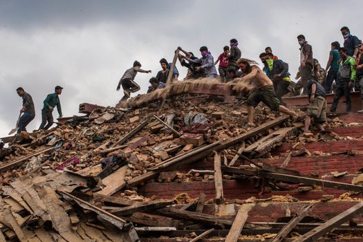 NEPAL,Kathmandu: People dig through the rubble in Kathmandu's Durbar Square on April 25, 2015, after a magnitude 7.8 earthquake hit the area.More than 8,000 people died in the quake and some 3.5 million were left homeless. 