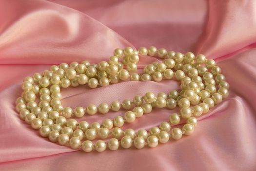 Pearl Necklace on delicate Pink silk background