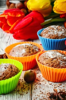 Sweet muffin tins and bouquet of fresh cut tulips
