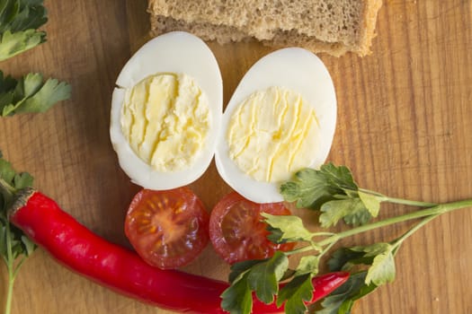 boiled egg, tomato, pepper on cutting board