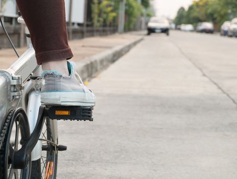 foot on pedal of bicycle ready for departure