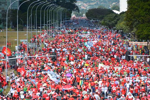 BRAZIL, Brasilia: Supporters of Brazilian President Dilma Rousseff protest in Brasilia as lawmakers vote on whether the impeachment of Rousseff will move forward, on April 17, 2016. Thousands of rival protesters gathered Sunday outside Brazil's Congress for a vote on President Dilma Rousseff's political future, waving flags, wearing opposing colors and separated by a wall. Rousseff, whose approval rating has plunged to a dismal 10 percent, faces charges of embellishing public accounts to mask the budget deficit during her 2014 reelection.