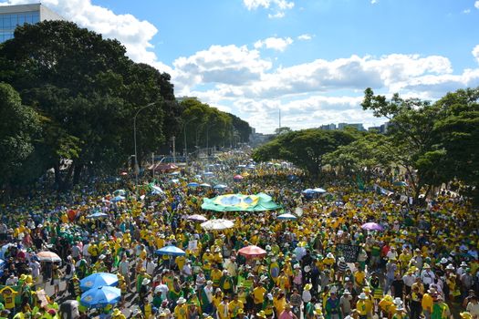 BRAZIL, Brasilia: Activists supporting the impeachment of Brazilian President Dilma Rousseff follow on big screens as lawmakers vote on whether the impeachment of Rousseff will move forward, in Brasilia, on April 17, 2016. Thousands of rival protesters gathered Sunday outside Brazil's Congress for a vote on President Dilma Rousseff's political future, waving flags, wearing opposing colors and separated by a wall. Rousseff, whose approval rating has plunged to a dismal 10 percent, faces charges of embellishing public accounts to mask the budget deficit during her 2014 reelection.
