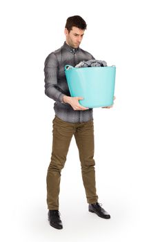 Full length portrait of a young man holding a laundry basket isolated on white background