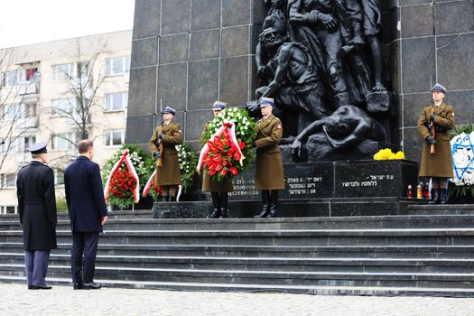 POLAND, Warsaw: An honor guard stands in front of the Ghetto Heroes Monument in Warsaw, Poland on April 19, 2016, on the 73rd anniversary of the Warsaw Ghetto uprising.Members of the state and local governments, ambassadors, as well as those who are Righteous Among Nations attended the anniversary. The ceremony took place at the spot of the first armed clashes in 1943. The uprising started when Jewish residents of the ghetto refused surrender to the Nazi police commander. The entire ghetto was burned and the clashes ended on May 16. An estimated 13,000 people in the ghetto were killed in the revolt.