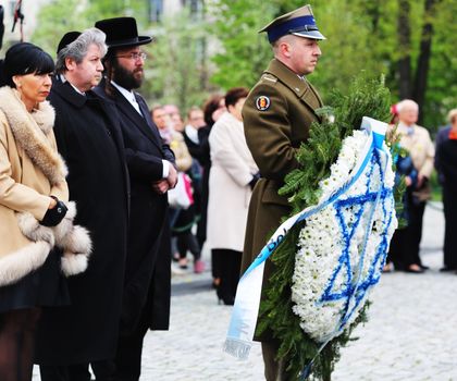 POLAND, Warsaw: A soldier holds a wreath at the Ghetto Heroes Monument in Warsaw, Poland on April 19, 2016, on the 73rd anniversary of the Warsaw Ghetto uprising.Members of the state and local governments, ambassadors, as well as those who are Righteous Among Nations attended the anniversary. The ceremony took place at the spot of the first armed clashes in 1943. The uprising started when Jewish residents of the ghetto refused surrender to the Nazi police commander. The entire ghetto was burned and the clashes ended on May 16. An estimated 13,000 people in the ghetto were killed in the revolt.
